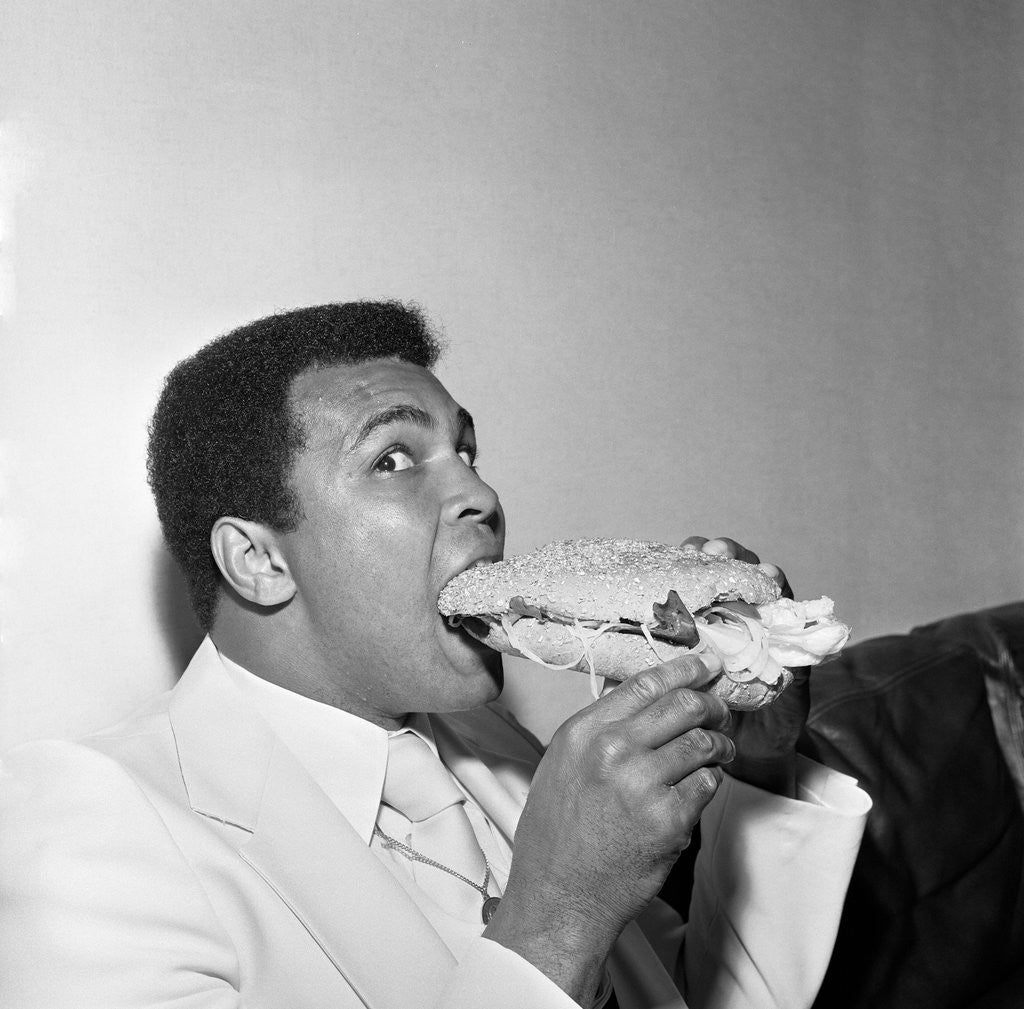 Detail of Muhammad Ali in Newcastle eating a Stottie cake 1977 by Dennis Hutchinson