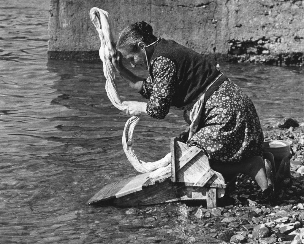 Detail of Woman washing clothes in a river, Portugal, 1973 by Tony Boxall