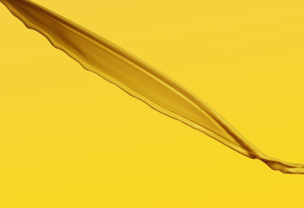 Detail of Pouring yellow liquid on yellow background by Corbis
