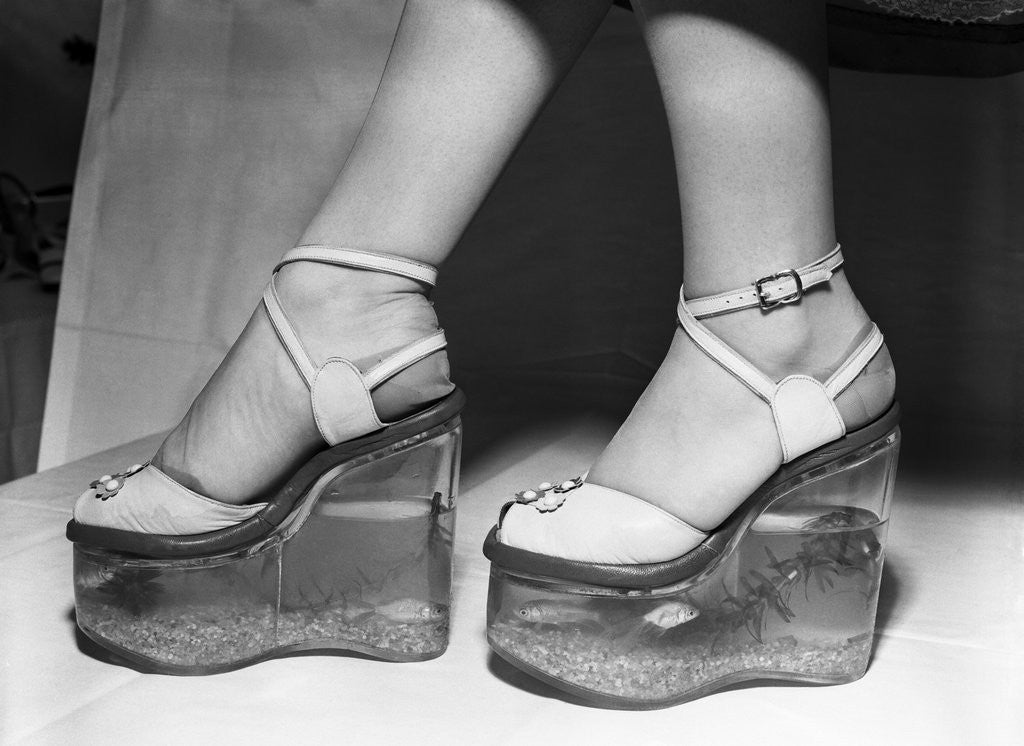 Detail of Woman wearing aquarium wedged shoes by Corbis