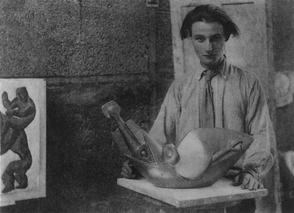 Detail of Henri Gaudier-Brzeska with his sculpture 'Bird Swallowing Fish' in Kettle's Yard, University of Cambridge, 1914 by English Photographer