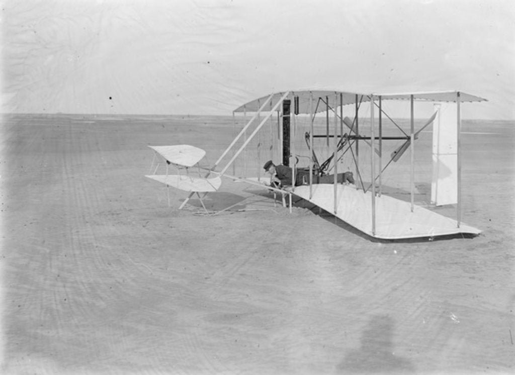 Detail of Wilbur in prone position in damaged machine on ground after unsuccessful trial in North Carolina, USA, 1903 by Anonymous