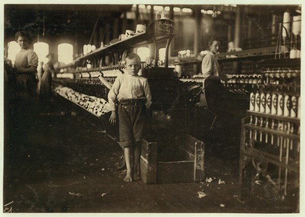 Detail of 8 year old Leo, only 4 feet tall, picks up bobbins for 15 cents a day at Elk Cotton Mills, Fayetteville, Tennessee, 1910 by Lewis Wickes Hine
