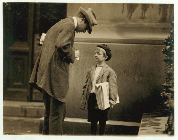 Detail of 8 year old newsboy Michael McNelis, who'd just recovered from his second bout of pneumonia, selling papers in a rain storm by Lewis Wickes Hine