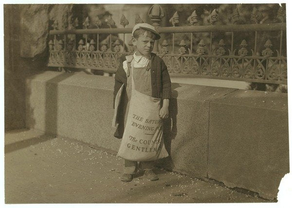 Detail of Newsboy Freddie Kafer, 5 or 6 years old, selling Saturday Evening Posts at the entrance to the State Capitol, Sacramento, California, 1915 by Lewis Wickes Hine