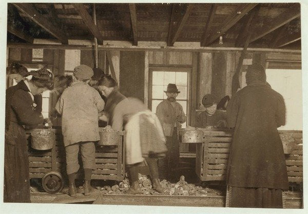 Detail of 10 year old Mike Murphy, 7 year old Annie Healy and 10 year old Ross Healy in the shucking shed at Alabama Canning Co, Bayou La Batre, Alabama, 1911 by Lewis Wickes Hine