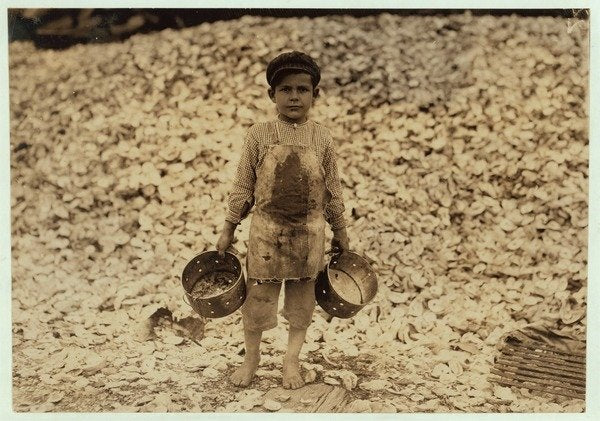 Detail of 5 year old migrant shrimp-picker Manuel in front of a pile of oyster shells by Lewis Wickes Hine
