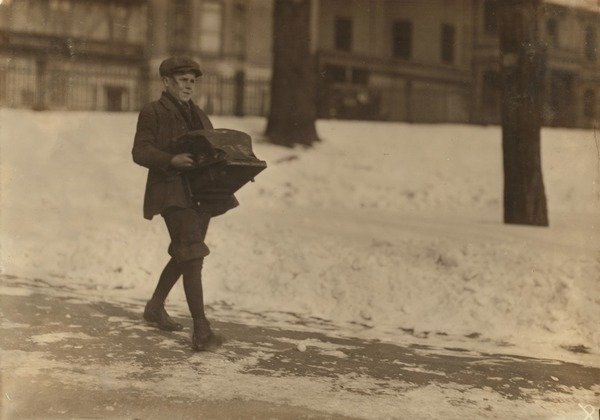 Detail of Louis A. Caulfield, aged 16, on Boston Common delivering a heavy type-writer about 1/2 mile for Model Typewriter Inspection Co. earning a week, 1917 by Lewis Wickes Hine
