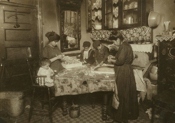 Detail of Mrs. Mette and her children making flowers in a dirty New York tenement, 1911 by Lewis Wickes Hine