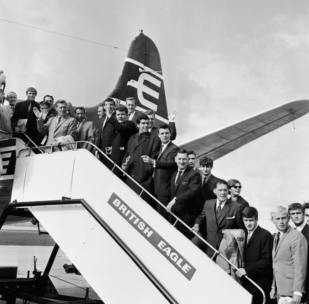 Detail of Everton team members wave before their plane departs from Speke airport by Charlie Owens