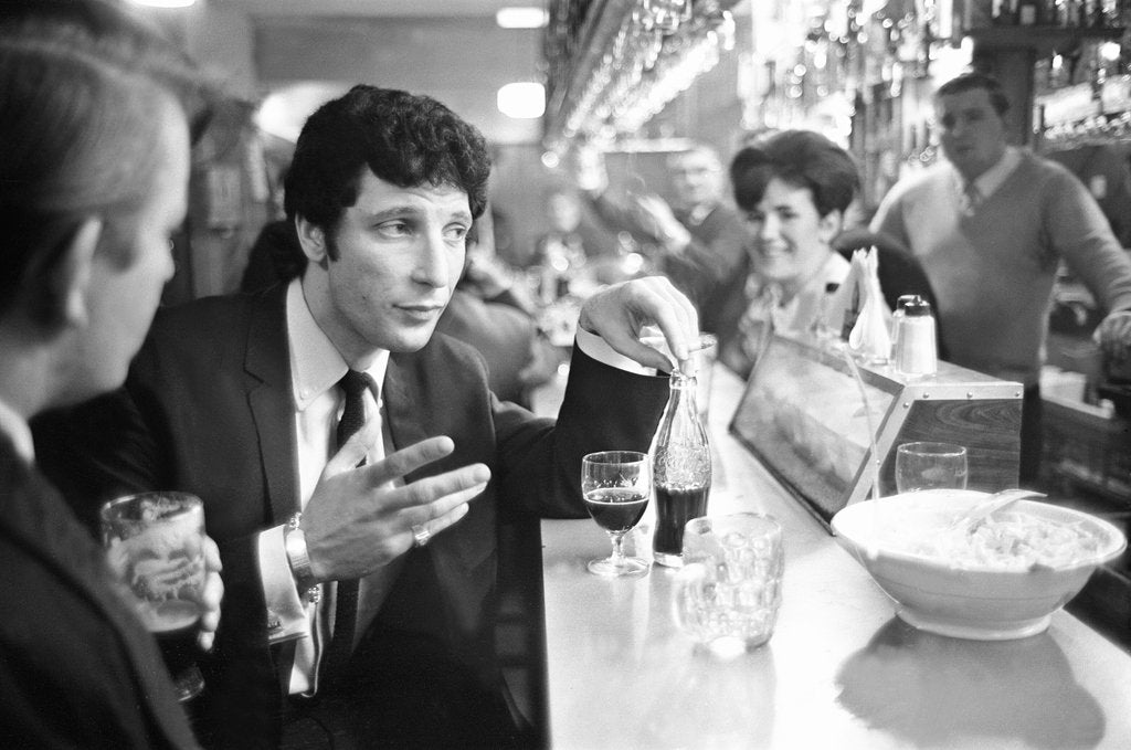 Detail of Tom Jones, enjoys a drink, 22nd February 1965. by Davies