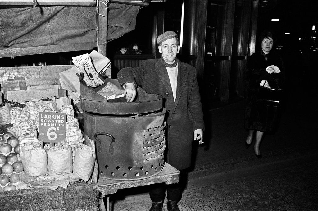 Detail of Hot Chestnut hawker in Leicester Square, London. 9th October 1963. by Tanner