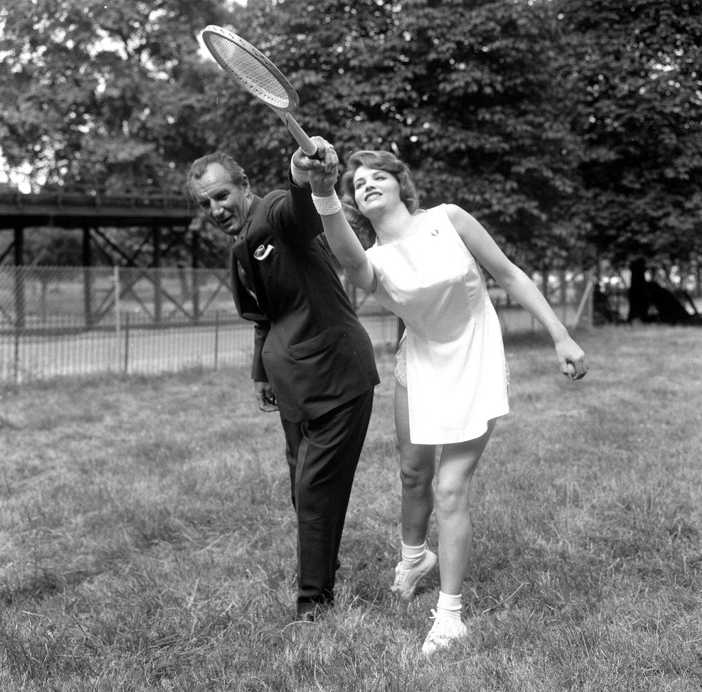 Detail of Fred Perry with actress Yvonne Buckingham, during a coaching session. by Staff