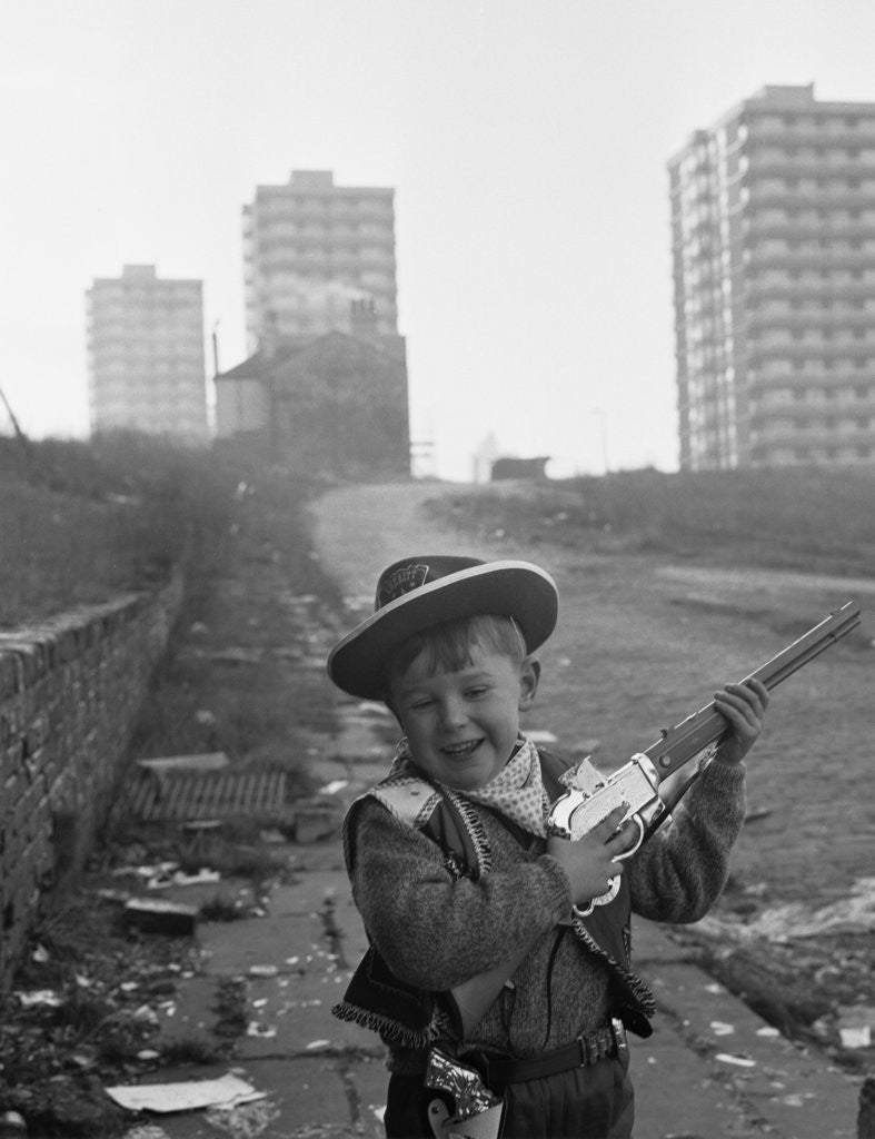 Detail of Young boy playing cowboys in Collyhurst by Dennis Hussey