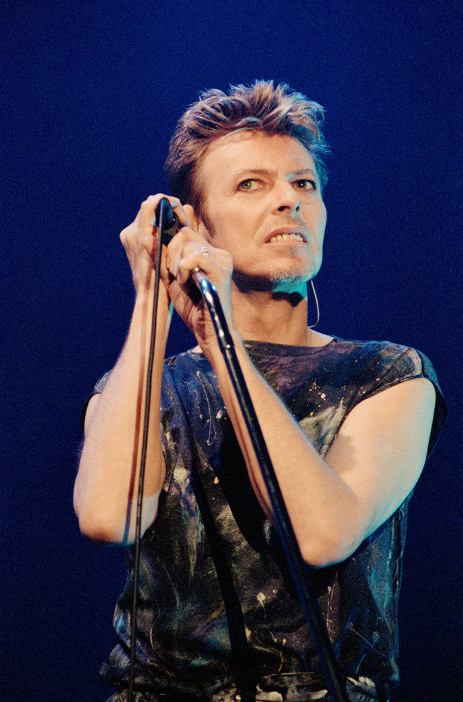 Detail of Pop star David Bowie performing on stage during a concert at The Scottish Exhibition and Conference Centre (SECC) in Glasgow. by John Gunion