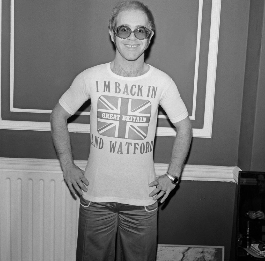 Detail of Elton John returns from America to announce that he is back in Britain for good. by Carl Bruin
