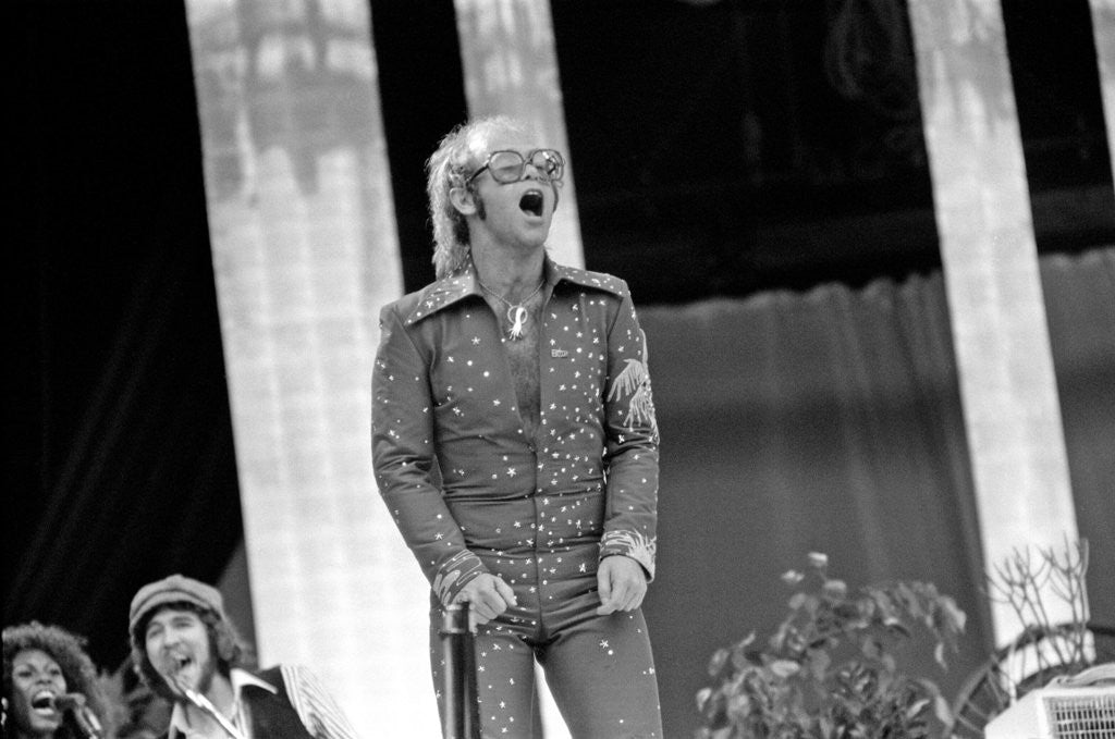 Detail of Elton John performing on stage at Wembley Stadium., London, England in June 1975 by Chris Barham