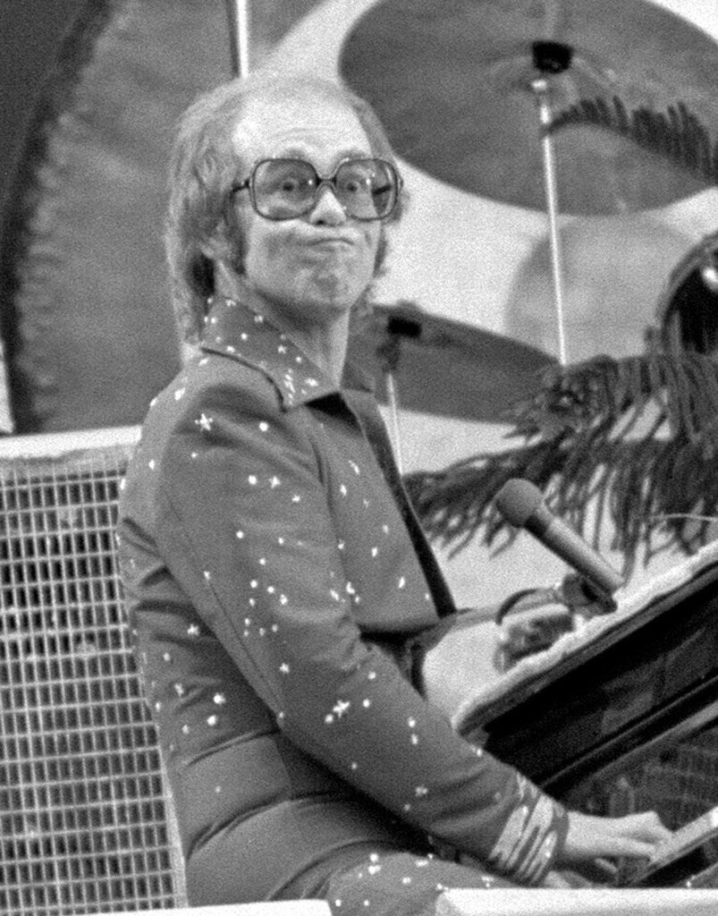 Detail of Elton John performing on stage at Wembley Stadium., London, England in June 1975 by Chris Barham
