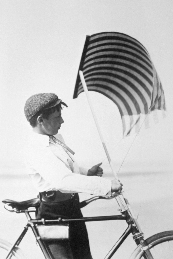 Detail of Adjusting the sail on the bike by Andrew Pitcairn-Knowles