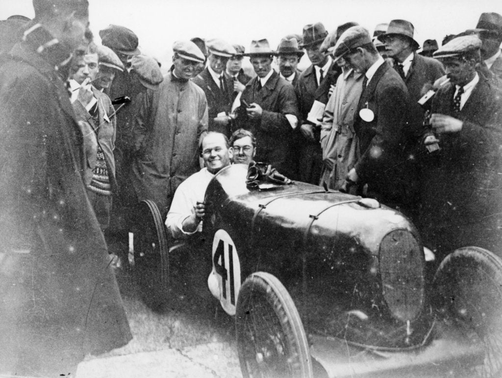 Detail of Gordon Taylor in a racing car surrounded by a crowd of men by Unknown