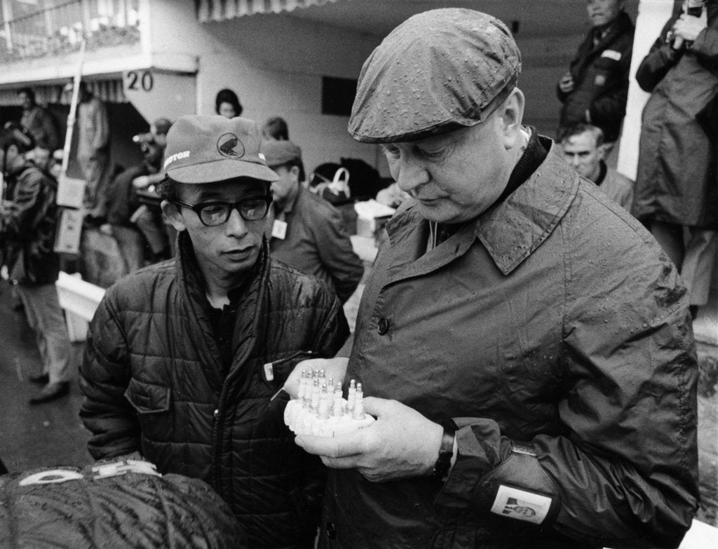 Detail of Honda technicians selecting the appropriate plugs by Unknown