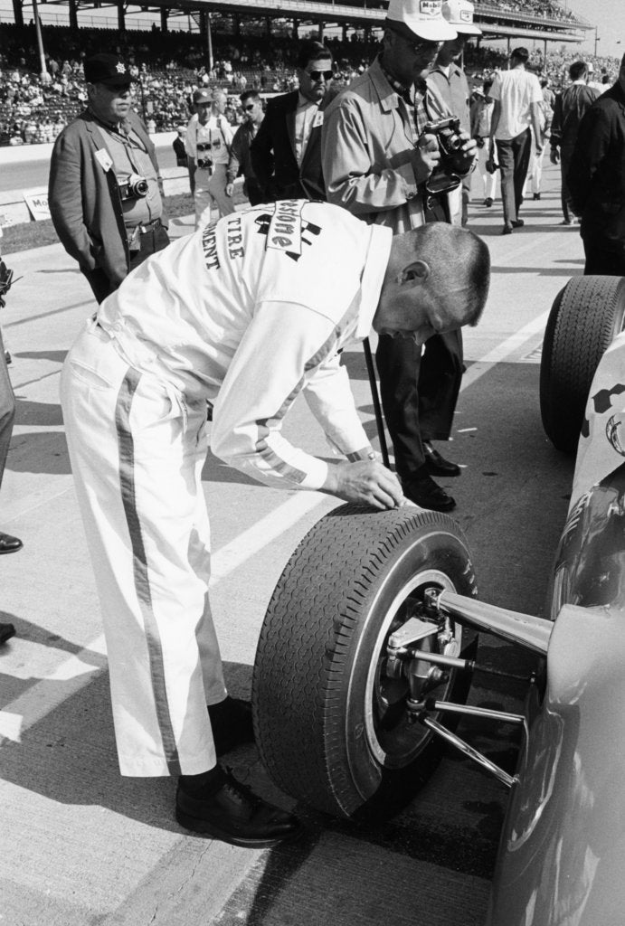 Detail of Technician checking tyre wear, Indianapolis, Indiana, USA, 1965 by Unknown