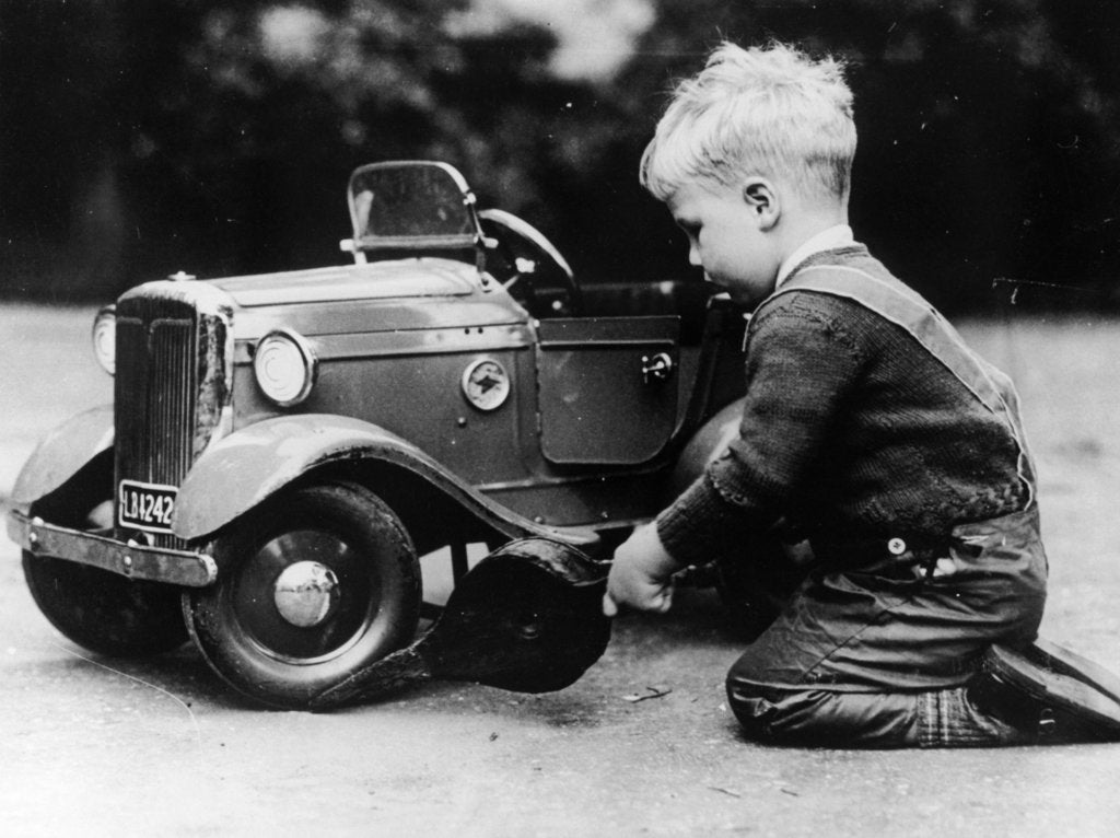 Detail of Michael Ware repairing a pedal car by Unknown