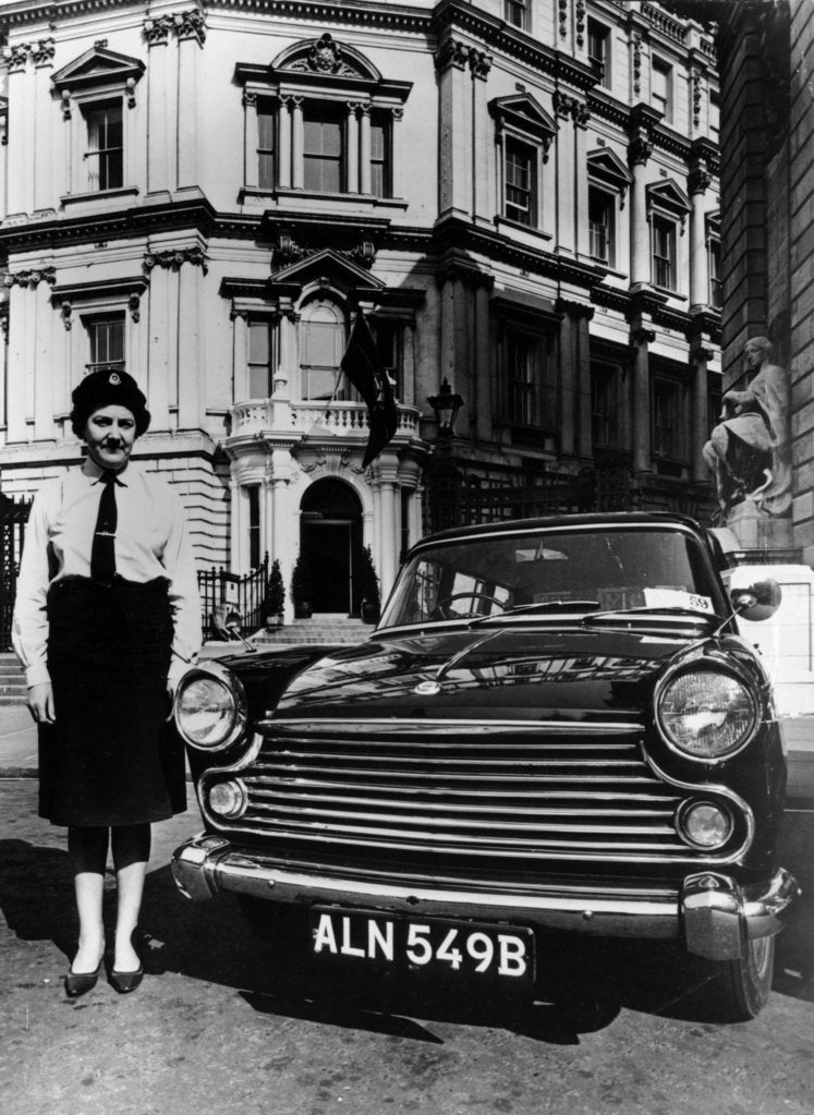 Detail of Female chauffeur standing by a 1964 Morris Oxford, 1964 by Unknown