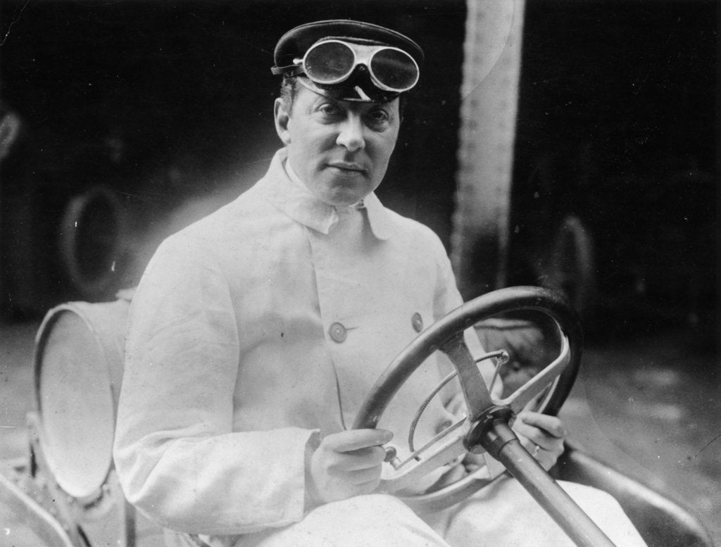 Detail of A man at the wheel of his car dressed in a driving coat and goggles by Unknown