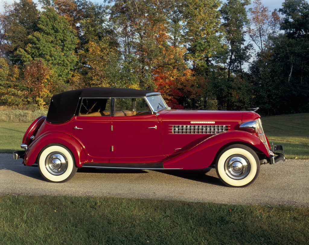Detail of A 1936 Auburn 852 car on a gravel driveway in the autumn sunlight by Unknown