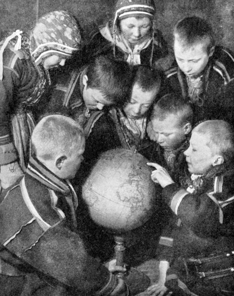 Detail of Lapp children looking at a globe by Anonymous