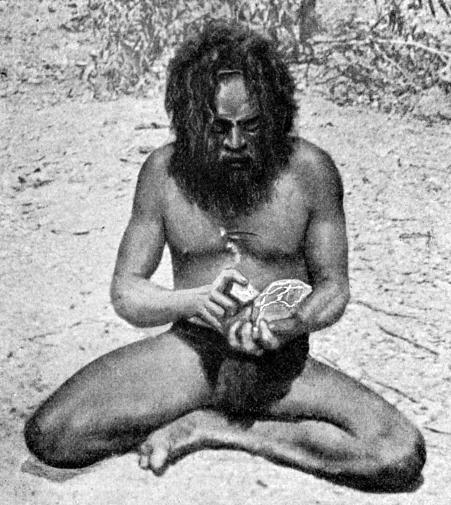 Detail of A man from the Warramunga tribe making a stone axe head, Australia by Spencer and Gillen