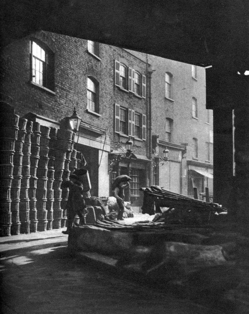 Detail of Fruit baskets piled against houses at Borough Market, London by Whiffin