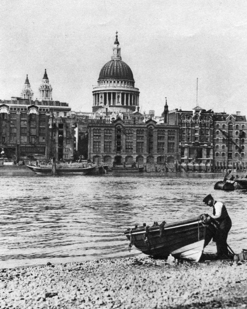 Detail of Thames waterman and his boat on the 'beach' at Bankside, London by McLeish