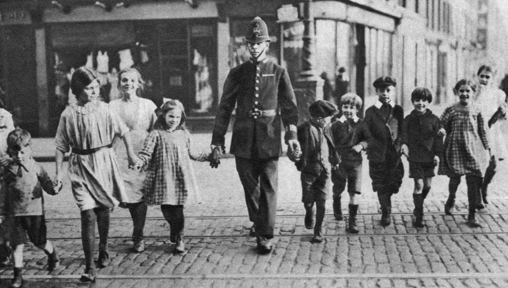 Detail of Policeman helping schoolchildren across the road, East End, London by Anonymous