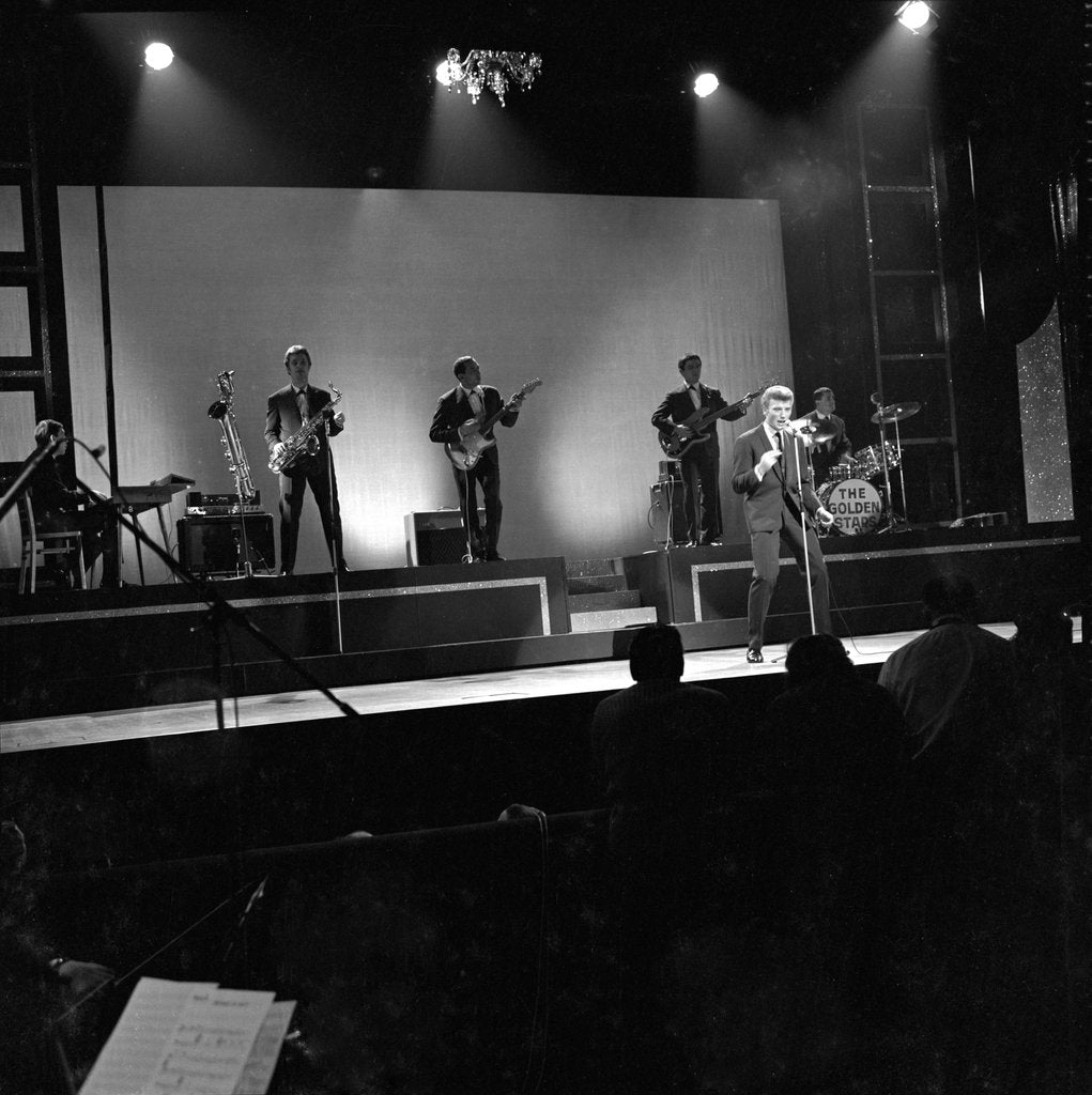 Detail of Johnny Hallyday with band performing on the Palladium Stage by Harry Hammond