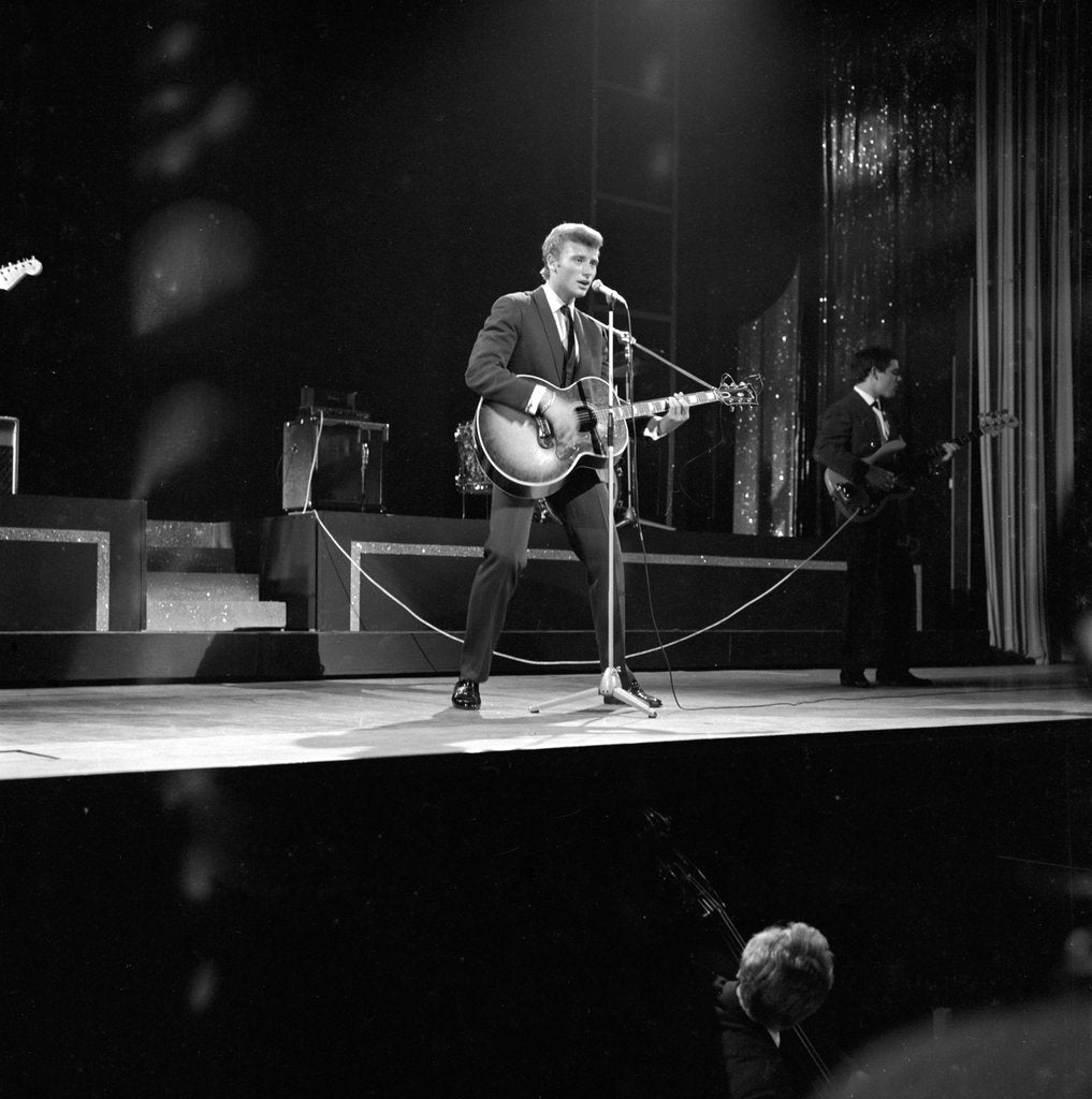 Detail of Johnny Hallyday with band performing on the Palladium Stage by Harry Hammond