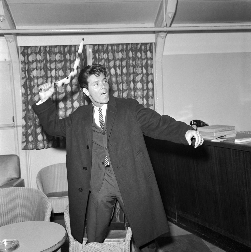 Detail of Cliff Richard playing with a boomerang by Harry Hammond