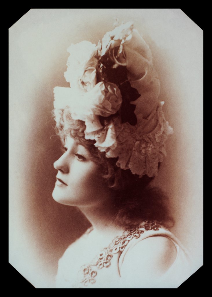 Detail of Belle Bilton wearing an ornate hat by Alexander Bassano