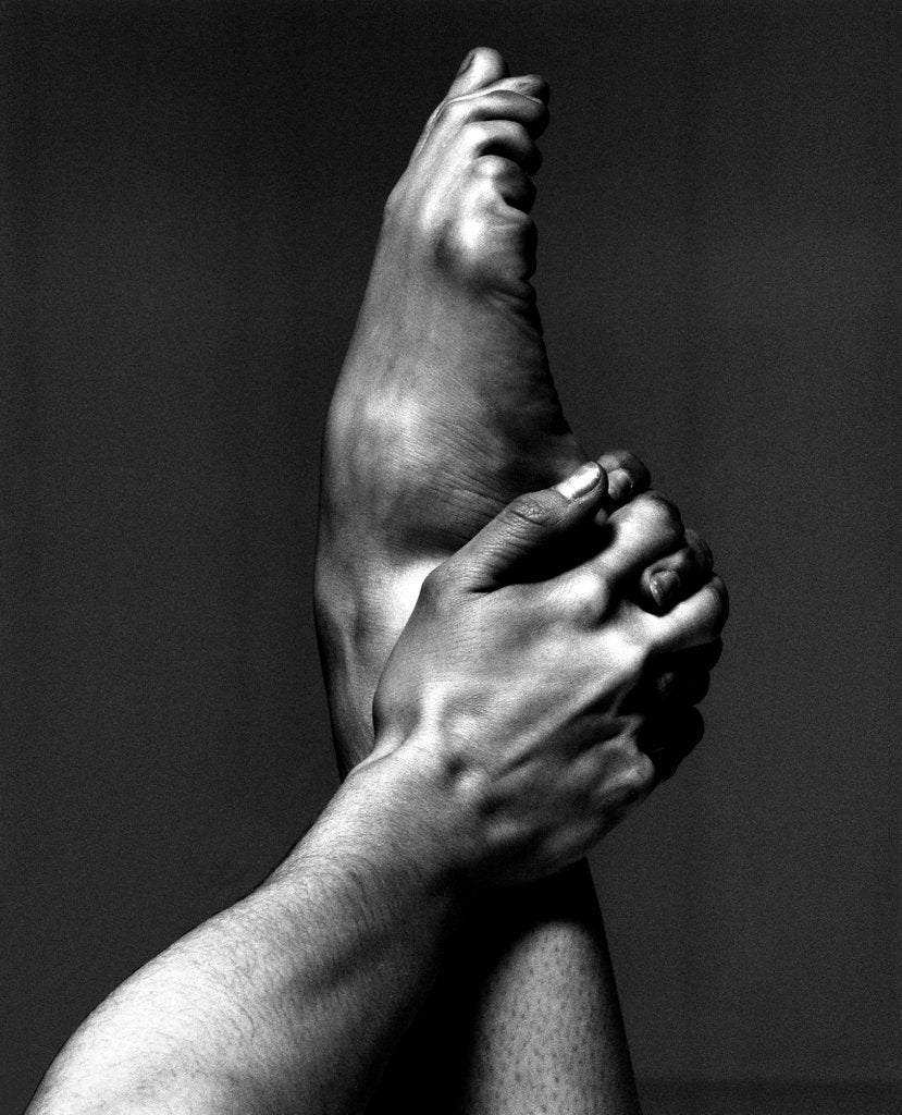 Detail of London Contemporary Dance School student's hand holding a foot by Anthony Crickmay