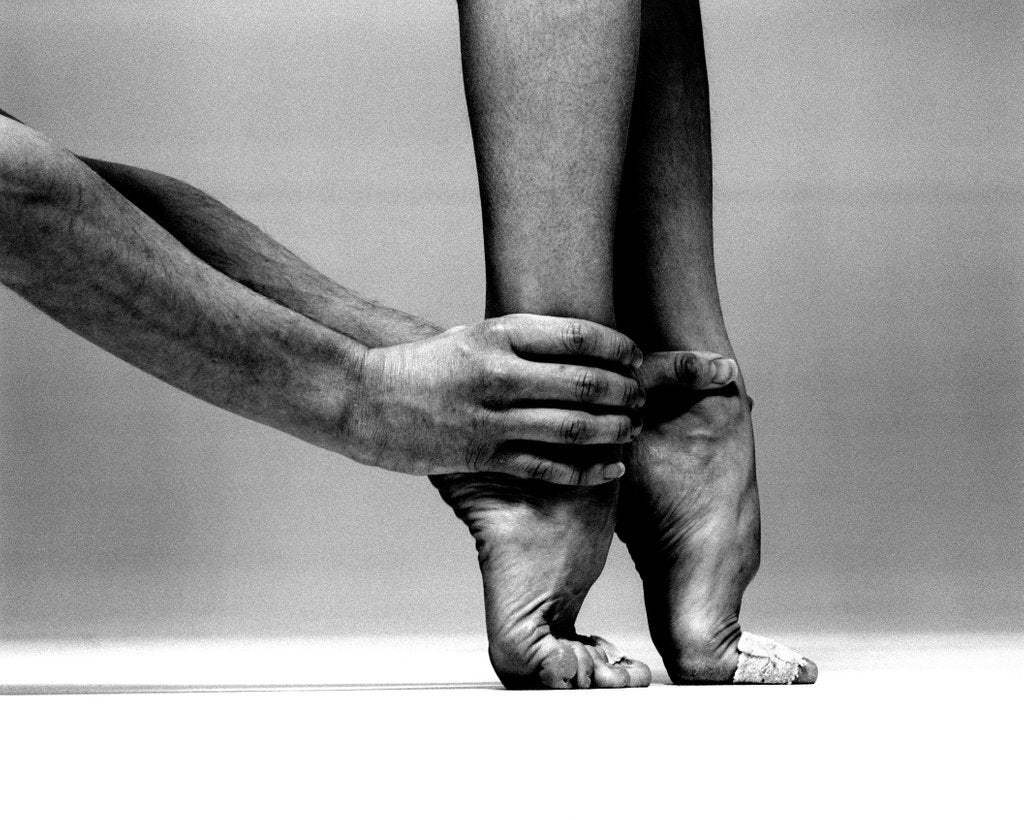 Detail of Lauren Potter's feet held by Jonathan Lunn by Anthony Crickmay