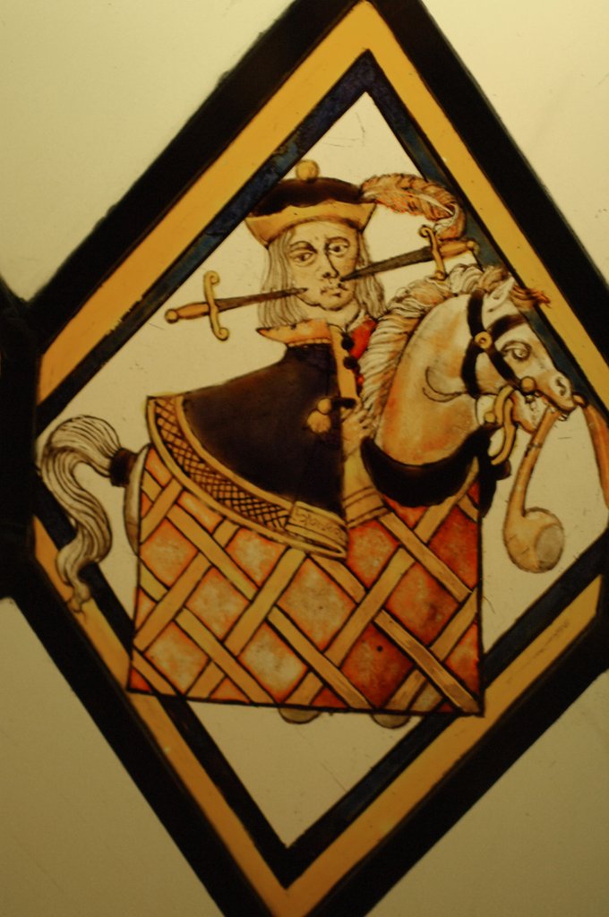 Detail of The Betley Window stained glass panel, detail of a man on a hobby horse by Stuart Cox