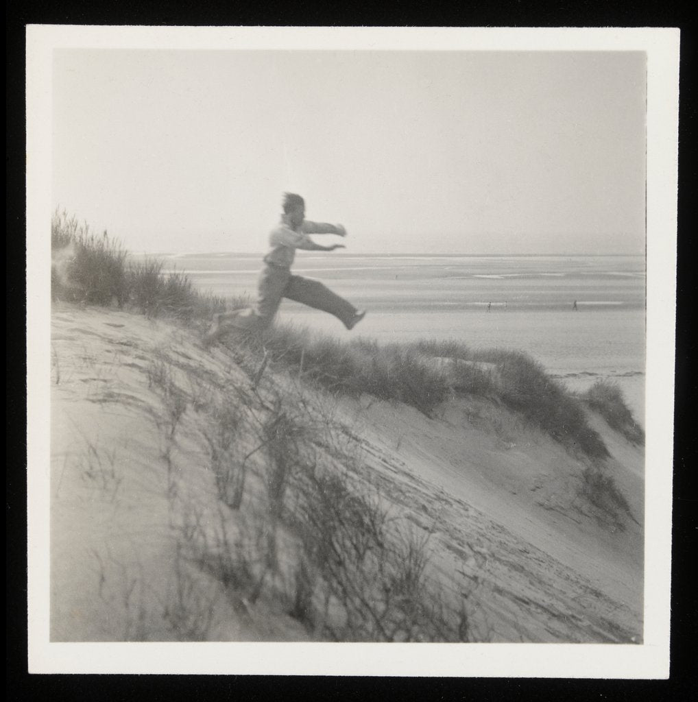 Detail of Man jumping off sand dune by Curtis Moffat