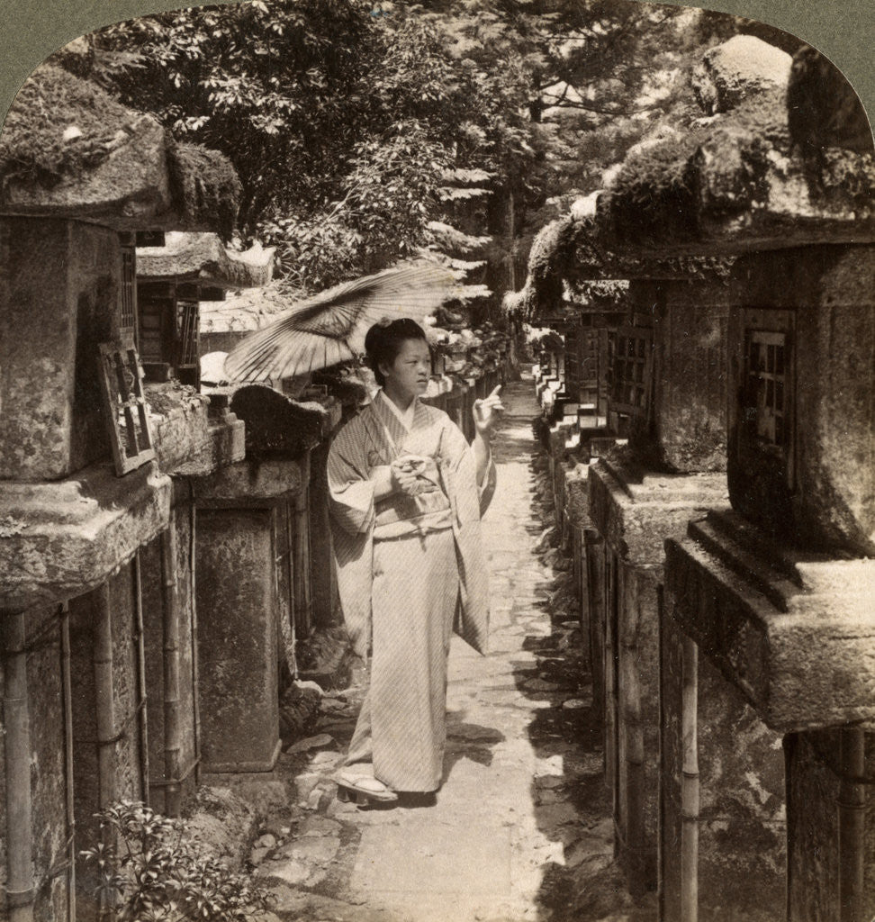 Detail of A woman Shinto devotee counting the stone lanterns, Kasuga Shrine, Nara, Japan by Underwood & Underwood