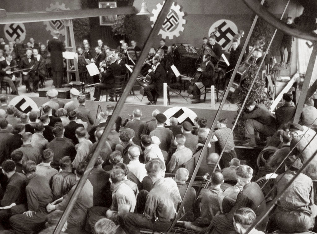 Detail of An orchestra plays to some factory workers as they take a break from work by Anonymous