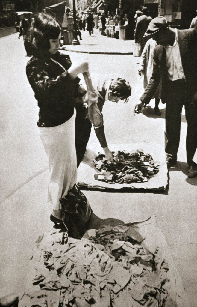 Detail of New York street trader selling stockings by Anonymous