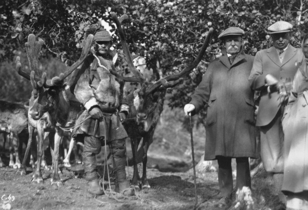 Detail of Tourists posing alongside a man with reindeer, Lyngen, Norway by Anonymous