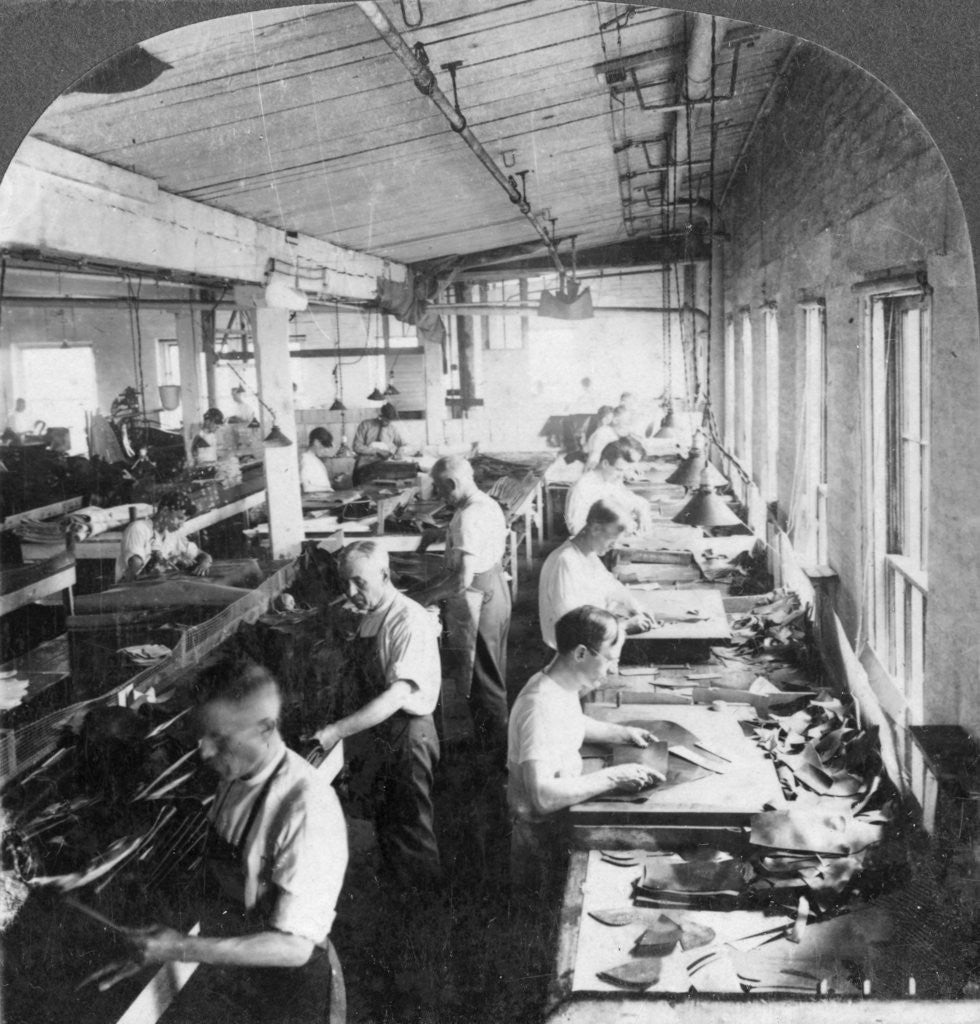 Detail of Workers cutting leather for shoes in a factory, Lynn, Massachusetts, USA by Keystone View Company