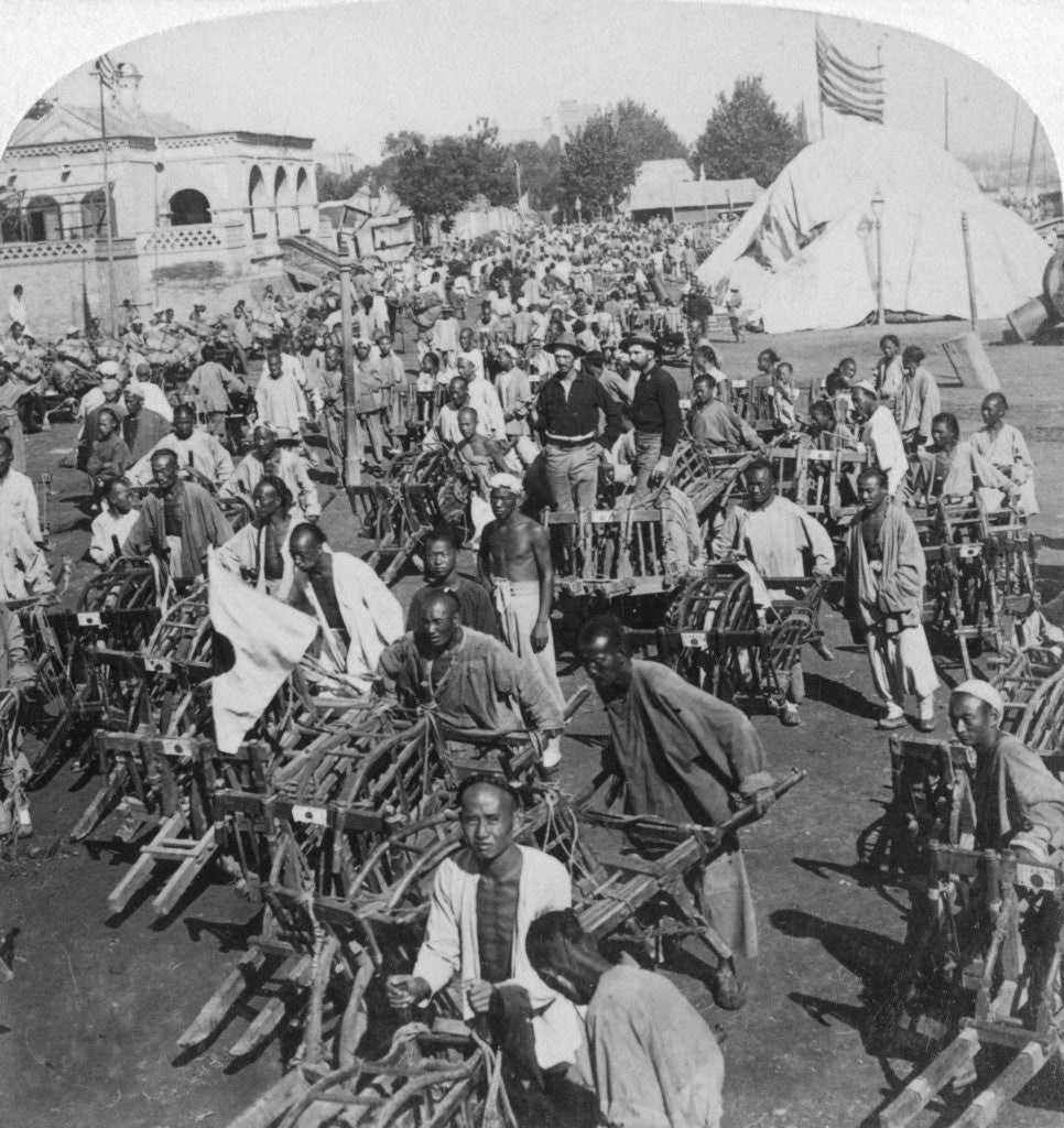 Detail of Wheelbarrow transportation at the boat landing by Underwood & Underwood
