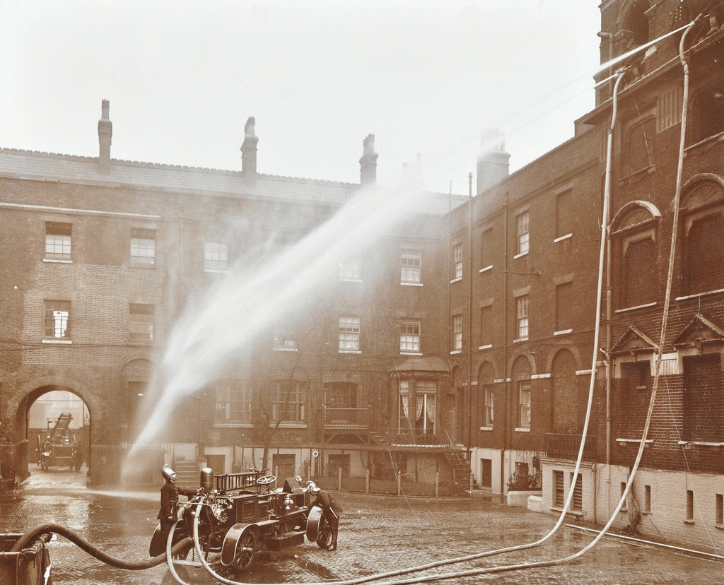Detail of Firemen demonstrating hoses worked by a petrol motor pump, London Fire Brigade Headquarters, 1909 by Unknown